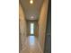 Bright hallway with decorative glass front door and neutral tile flooring at 8933 Hinsdale Heights Dr, Polk City, FL 33868