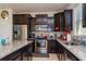 Well-equipped kitchen with stainless steel appliances, granite countertops, and dark wood cabinetry at 8933 Hinsdale Heights Dr, Polk City, FL 33868