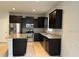 Kitchen with granite countertops, stainless steel appliances, and dark wood cabinets at 8933 Hinsdale Heights Dr, Polk City, FL 33868