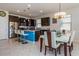 Open kitchen with island, breakfast bar, stainless appliances, and adjacent dining area at 8933 Hinsdale Heights Dr, Polk City, FL 33868