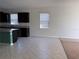 Eat-in kitchen with tile floors, dark cabinetry, and a view of the backyard at 8933 Hinsdale Heights Dr, Polk City, FL 33868