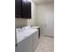 Functional laundry room with washer, dryer, utility sink and overhead cabinets at 8933 Hinsdale Heights Dr, Polk City, FL 33868
