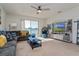 Cozy living room with a comfortable gray sofa, large windows, and water views at 8933 Hinsdale Heights Dr, Polk City, FL 33868