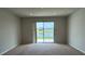 Living Room with sliding glass doors opening to the pond at 8933 Hinsdale Heights Dr, Polk City, FL 33868