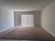 Spacious carpeted living room with sliding glass door providing natural light at 8933 Hinsdale Heights Dr, Polk City, FL 33868