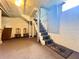 The basement featuring a staircase with carpet, and unfinished walls and ceiling at 900 Carlton Ave, Lake Wales, FL 33853