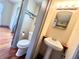 Small bathroom with corner sink, mirror, and toilet at 900 Carlton Ave, Lake Wales, FL 33853