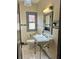 This bathroom has an antique sink, white tile and a window at 900 Carlton Ave, Lake Wales, FL 33853