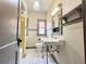 Bathroom with white tiled floor, white fixtures, and built in shelves at 900 Carlton Ave, Lake Wales, FL 33853