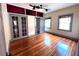 This is a bedroom with hardwood floors, two windows and a ceiling fan at 900 Carlton Ave, Lake Wales, FL 33853