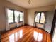 Bright bedroom with hardwood floors, neutral walls, and multiple windows for natural light at 900 Carlton Ave, Lake Wales, FL 33853