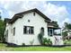 Elegant stucco home with manicured landscaping, showcasing its classic architectural design and charming curb appeal at 900 Carlton Ave, Lake Wales, FL 33853