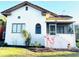 Charming home with a stucco exterior, terra cotta roof, a screened porch, and landscaped front yard at 900 Carlton Ave, Lake Wales, FL 33853