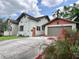 Charming home with a detached garage and a well-maintained driveway, showcasing the property's curb appeal at 900 Carlton Ave, Lake Wales, FL 33853