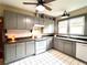 Well-lit kitchen with gray cabinetry, white appliances, and a window over the sink at 900 Carlton Ave, Lake Wales, FL 33853
