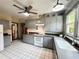 Charming kitchen with gray cabinets, white appliances, and a large window providing natural light at 900 Carlton Ave, Lake Wales, FL 33853