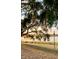 Dusk at the lakefront with a mature oak tree in the foreground at 900 Carlton Ave, Lake Wales, FL 33853
