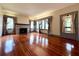 Elegant living room with a brick fireplace, hardwood floors, and stylish decor, creating a sophisticated and welcoming space at 900 Carlton Ave, Lake Wales, FL 33853