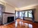 Inviting living room with brick fireplace and large windows, perfect for cozy evenings and natural light at 900 Carlton Ave, Lake Wales, FL 33853