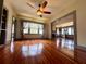 Bright living room featuring hardwood floors, a ceiling fan, and large windows for ample natural light at 900 Carlton Ave, Lake Wales, FL 33853