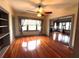 Bright living room with hardwood floors, ceiling fan, and doorway to the formal dining room at 900 Carlton Ave, Lake Wales, FL 33853