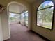 Charming screened porch with views of the neighborhood, blending indoor comfort with outdoor scenery at 900 Carlton Ave, Lake Wales, FL 33853