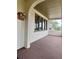 Inviting covered porch featuring a textured floor, natural light, and a view of the neighborhood at 900 Carlton Ave, Lake Wales, FL 33853