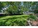 Large backyard featuring a lush lawn, mature trees, and a privacy fence at 915 Oregon St, Orlando, FL 32803