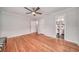 Bright bedroom with hardwood floors, ceiling fan, and ensuite bathroom entrance at 915 Oregon St, Orlando, FL 32803