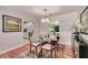 Elegant dining room boasts hardwood floors, chic lighting, and seamless access to the kitchen at 915 Oregon St, Orlando, FL 32803