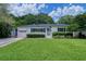 Charming single-story home features a lush green lawn, well-manicured hedges, and an attached one car garage at 915 Oregon St, Orlando, FL 32803