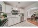 Bright kitchen area featuring stainless steel appliances, white cabinetry, and views of the dining area at 915 Oregon St, Orlando, FL 32803