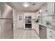 Well-lit kitchen with stainless steel appliances, white cabinets, and tiled floors at 915 Oregon St, Orlando, FL 32803