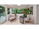 Inviting sunroom featuring neutral tile flooring, an abundance of natural light, and a peaceful setting at 915 Oregon St, Orlando, FL 32803