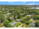 Expansive aerial view of a residential area with mature trees, a lake, and glimpses of the city skyline at 927 Boardman St, Orlando, FL 32804