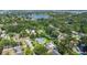 Residential neighborhood showcases homes with pools, surrounded by lush trees, and a glimpse of a nearby lake at 927 Boardman St, Orlando, FL 32804