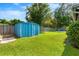 Spacious backyard featuring a well-kept lawn, storage shed, and patio set, perfect for outdoor entertaining at 927 Boardman St, Orlando, FL 32804
