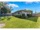 Well-maintained backyard featuring lush green grass and a view of the home's exterior and pool area at 927 Boardman St, Orlando, FL 32804