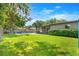 Spacious backyard featuring a pool, patio area, and lush green lawn, perfect for outdoor gatherings at 927 Boardman St, Orlando, FL 32804