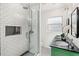 Modern bathroom featuring subway tile shower, black and white tile floor, and double vanity at 927 Boardman St, Orlando, FL 32804