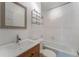 Bathroom with white vanity, mirror, toilet, and tiled shower-tub combo at 927 Boardman St, Orlando, FL 32804