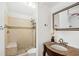 Tiled bathroom with a glass shower, granite vanity, and modern fixtures at 927 Boardman St, Orlando, FL 32804