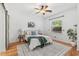 Comfortable bedroom showcasing hardwood floors, a ceiling fan, a large window and a cozy bed at 927 Boardman St, Orlando, FL 32804