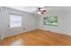 Bright bedroom with hardwood floors, two windows, and ceiling fan at 927 Boardman St, Orlando, FL 32804