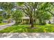 Charming single-story home with a brick driveway, lush landscaping, mature trees and inviting curb appeal at 927 Boardman St, Orlando, FL 32804
