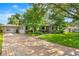 Charming single-story home with a brick driveway, lush landscaping, and inviting curb appeal at 927 Boardman St, Orlando, FL 32804