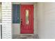 Close-up of a charming red front door with decorative glass panel, set against a light-colored exterior at 927 Boardman St, Orlando, FL 32804