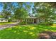 Well-maintained home featuring a verdant lawn, mature trees, and a welcoming entrance at 927 Boardman St, Orlando, FL 32804