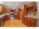 Spacious kitchen features wooden cabinets, stainless steel appliances, granite countertops, backsplash and hardwood flooring at 927 Boardman St, Orlando, FL 32804