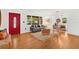 Inviting living room featuring hardwood floors, a comfortable sofa, and a bright red front door at 927 Boardman St, Orlando, FL 32804